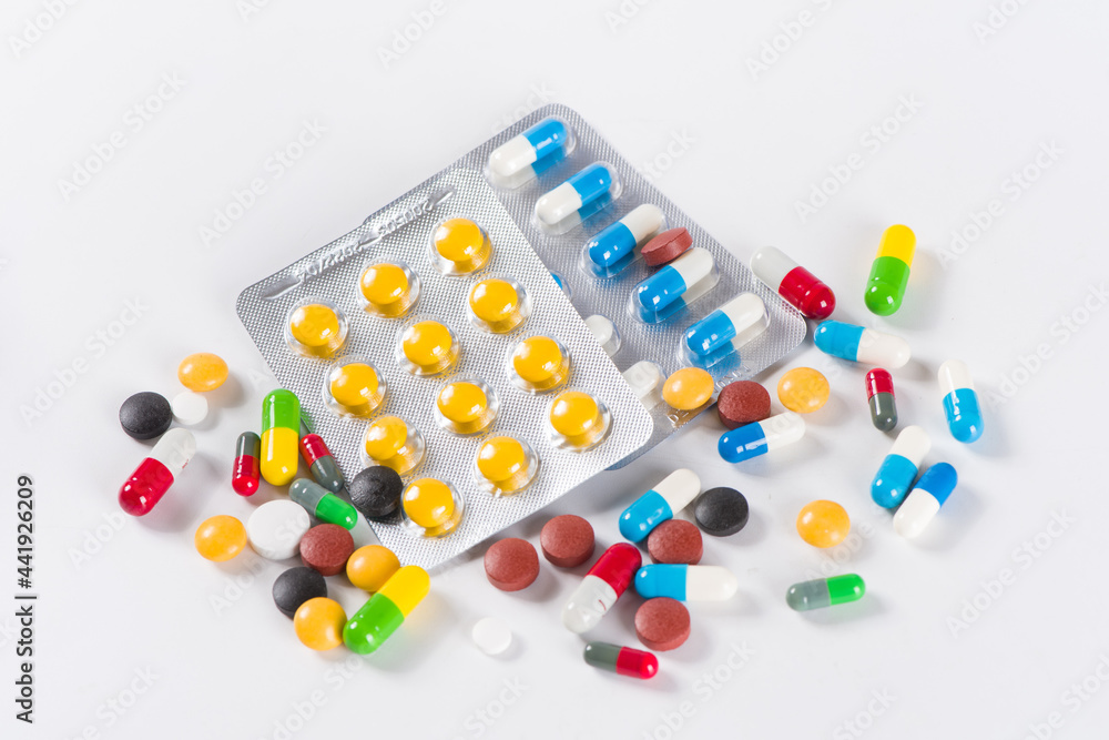 Assorted pharmaceutical medicine pills, tablets and capsules on white background Assorted pharmaceutical medicine pills, tablets and capsules on white background