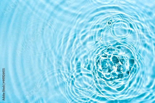 Abstract transparent liquid background with concentric circles and ripples. Spa beauty concept. Soft focus