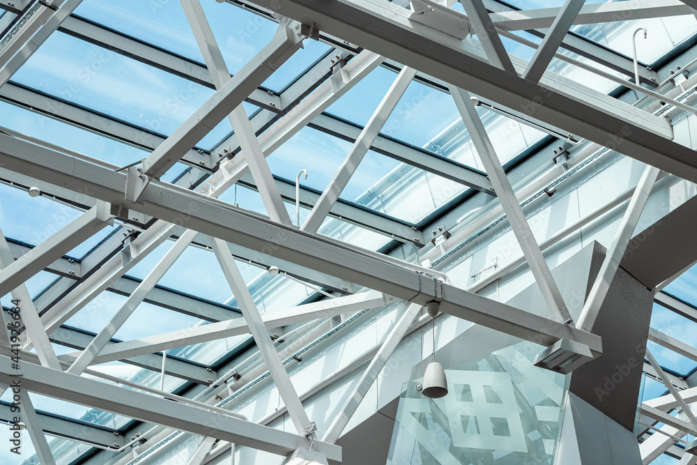Transparent glass ceiling, Abstract metal structure. Ceiling with crossed metal beams. Metal roof with windows.