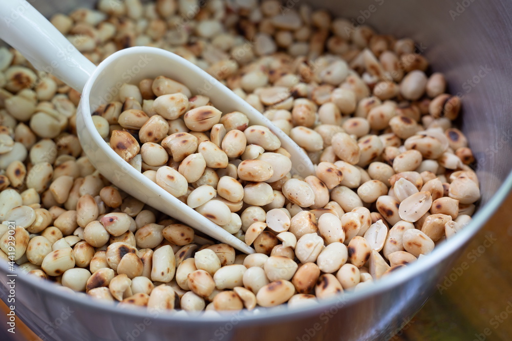 Roasted peanuts on a scoop in bowl. Roasted peanuts on a scoop in bowl.