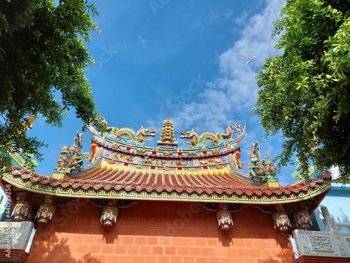 top religious oriental sculpture on the roof of Taiwan temple with blue sky design for holy and belief concept