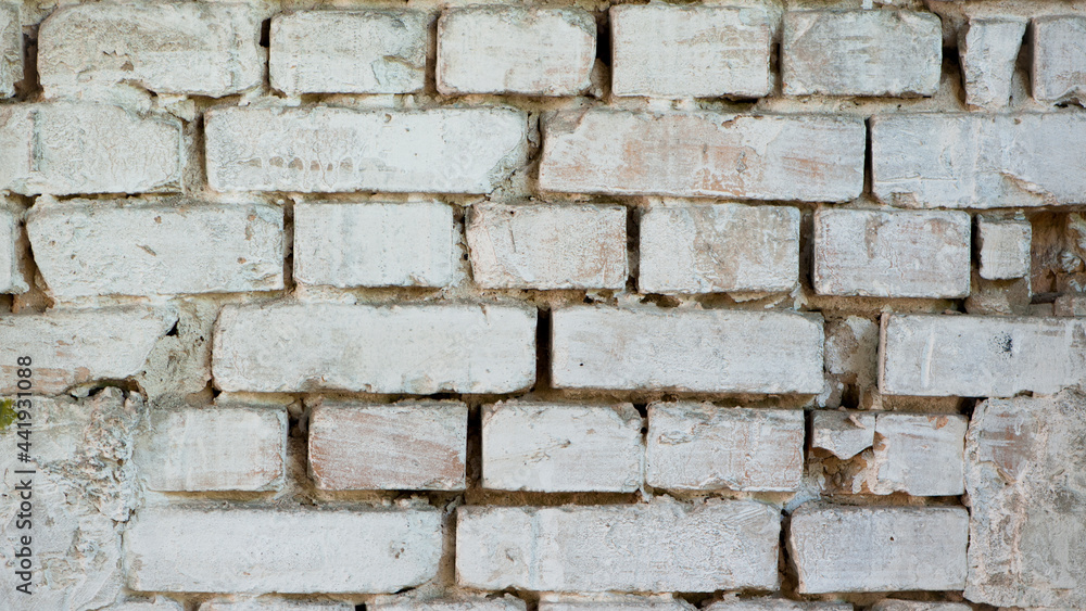 Abstract old white brick wall. background facade brick wall black and white. Vintage old brick wall texture. Grunge stone wall horizontal background. Dilapidated building facade with damaged plaster. Abstract old white brick wall. background facade brick wall black and white. Vintage old brick wall texture. Grunge stone wall horizontal background. Dilapidated building facade with damaged plaster.