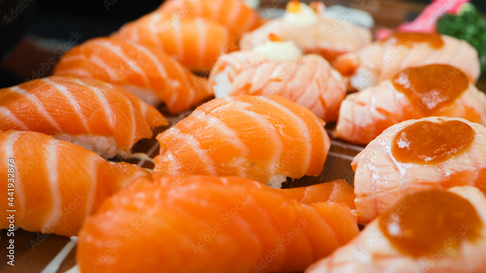 Salmon Sushi Japanese food. on the table in restaurant. Japanese cuisine set of Sashimi Salmon sushi nigiri. Salmon Sushi Japanese food. on the table in restaurant. Japanese cuisine set of Sashimi Salmon sushi nigiri.