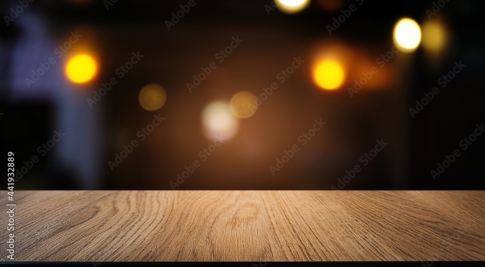 Empty wood table top and blur of night market background/selective focus .For montage product display.