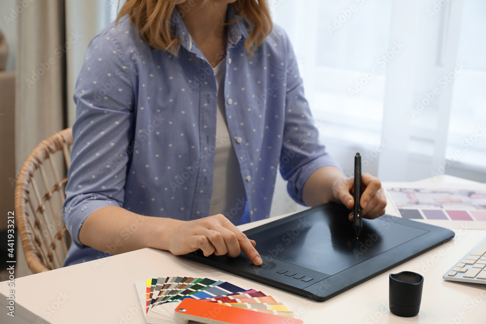 Professional designer with graphic tablet at table indoors, closeup Professional designer with graphic tablet at table indoors, closeup