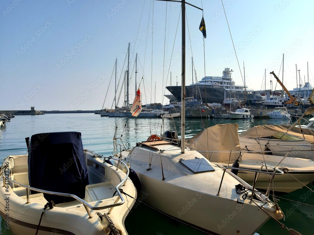 Liguria, Italy - June 17, 2021: Travelling around the ligurian seaside. Panoramic view to the seaside and the old villages. Beautiful view to the port with some boats in summer days. Liguria, Italy - June 17, 2021: Travelling around the ligurian seaside. Panoramic view to the seaside and the old villages. Beautiful view to the port with some boats in summer days.