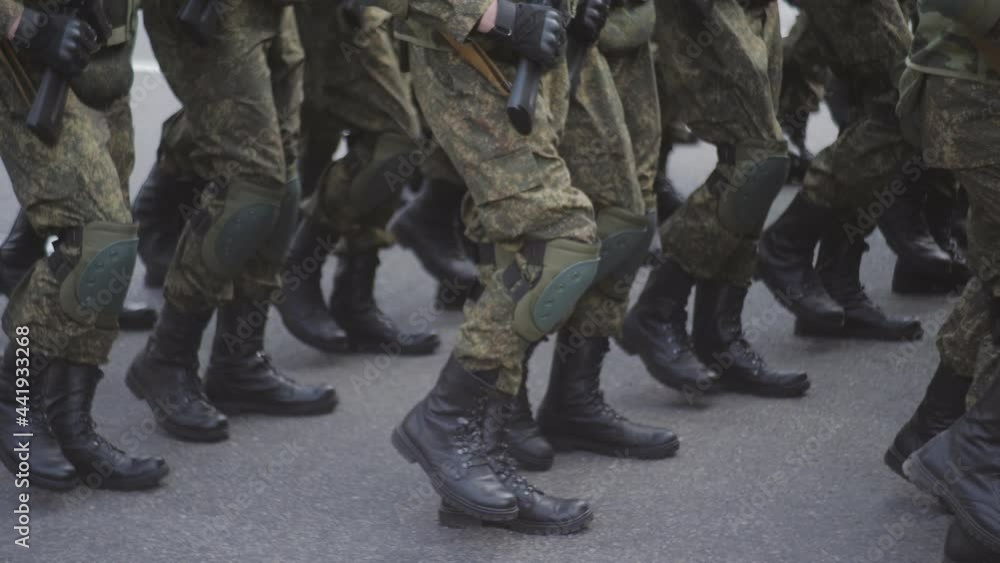 Soldiers march on the spot during demonstrations or military parades. Close-up of legs in army boots and knee pads. Soldiers march on the spot during demonstrations or military parades. Close-up of legs in army boots and knee pads.