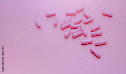 Pink capsules pill on pink background. Vitamins and supplements. Online pharmacy. Pharmacy store banner. Pharmaceutical industry. Woman's health insurance concept. Pills for love and happy life.