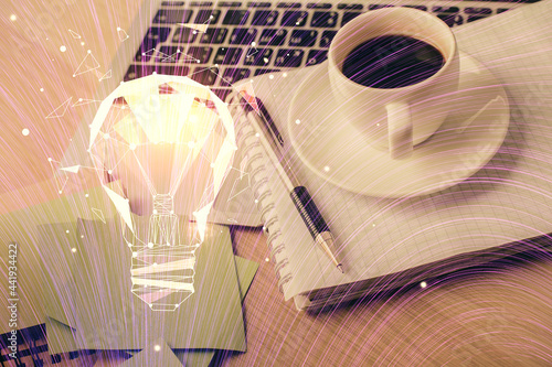 Double exposure of bulb drawing and desktop with coffee and items on table background. Concept of ideas.