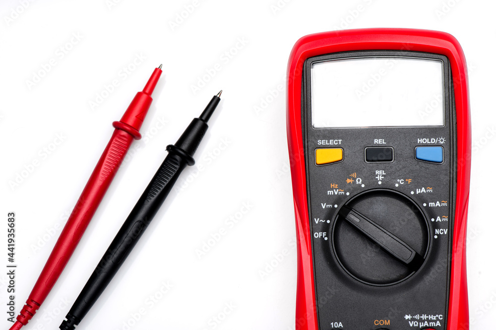 Electronic digital multimeter isolated on white with probes. Digital multimeter with red and black leads. Electronic multimeter isolated on white background close up Electronic digital multimeter isolated on white with probes. Digital multimeter with red and black leads. Electronic multimeter isolated on white background close up