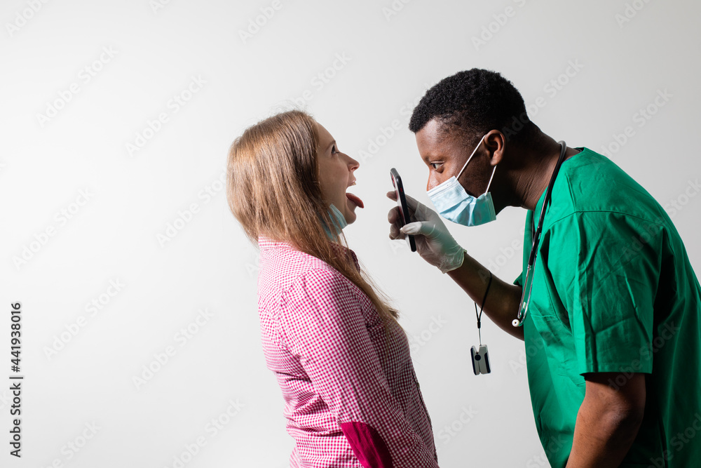 Doctor uses smartphone light to check patient's throat Doctor uses smartphone light to check patient's throat