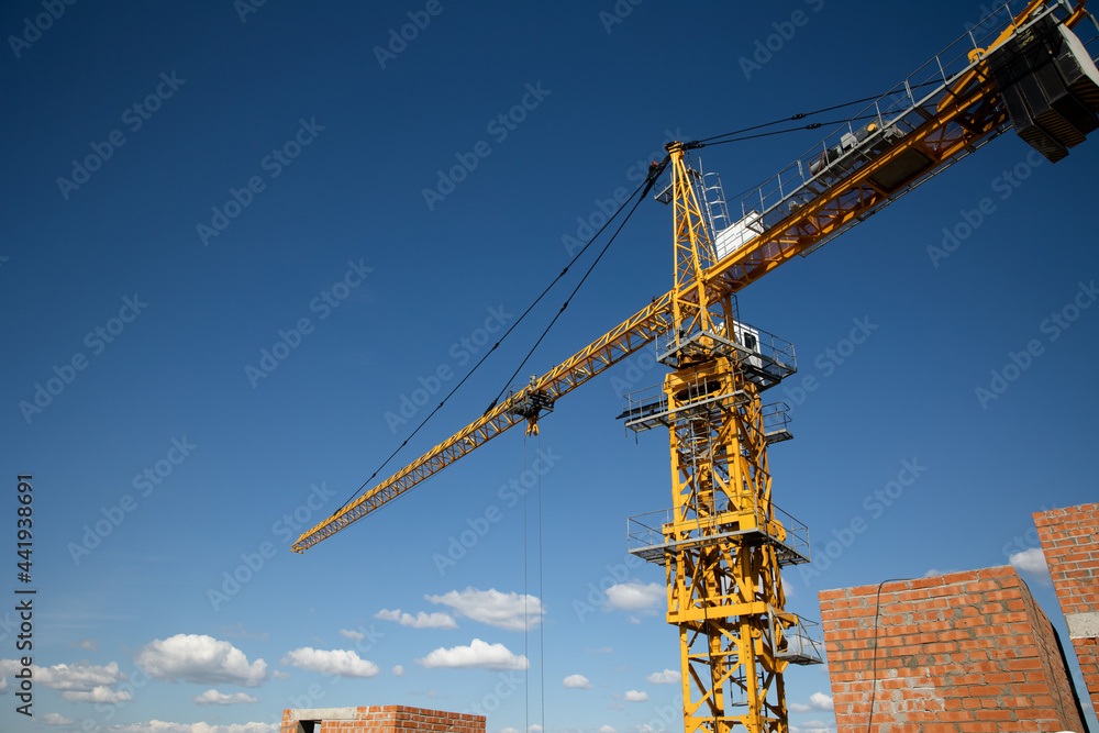 The process of building a house. metal structures. Construction concept. Tower cranes are building a new residential building.