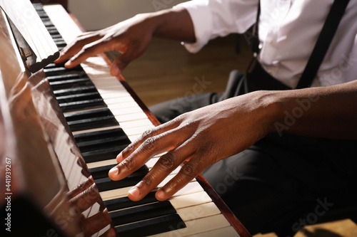 Fotografija African-American man playing piano indoors, closeup