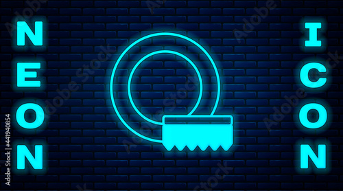 Glowing neon Washing dishes icon isolated on brick wall background. Cleaning dishes icon. Dishwasher sign. Clean tableware sign. Vector
