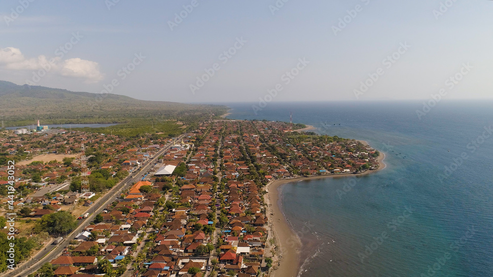 Aerial view coastal port city Gilimanuk place where ferry port for departure from Bali to the island of Java is located. Coastal city on the coast.