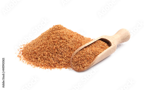 Natural coconut sugar and wooden scoop on white background