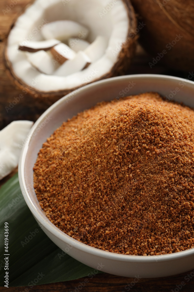 Natural coconut sugar in ceramic bowl on table, closeup Natural coconut sugar in ceramic bowl on table, closeup