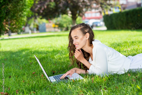 young woman and laptop in the park