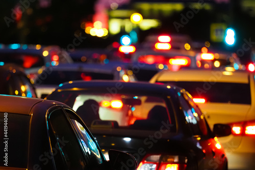 Traffic jams in the night city. Row of cars on the road at night and bokeh lights