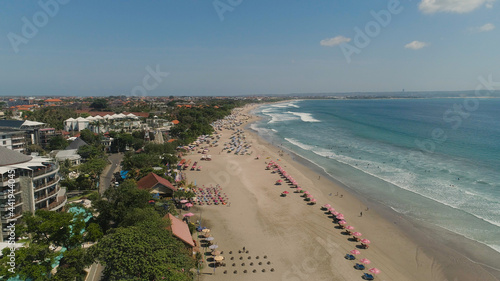 Aerial view sand beach with resting people, hotels and tourists, sun umbrellas, Bali, Kuta. surfers on water surface. Seascape, beach, ocean, sky sea Travel concept © Alex Traveler