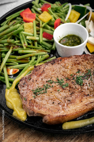 organic tenderloin beef steak sizzler on hot plate meal platter photo