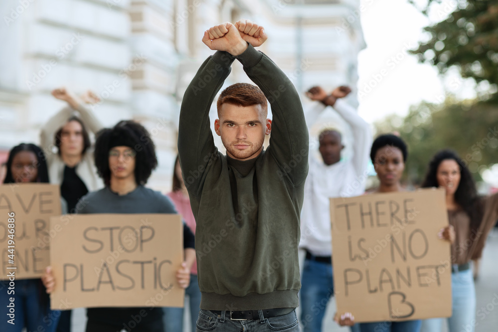 Caucasian guy leader leading international group of protestors Caucasian guy leader leading international group of protestors