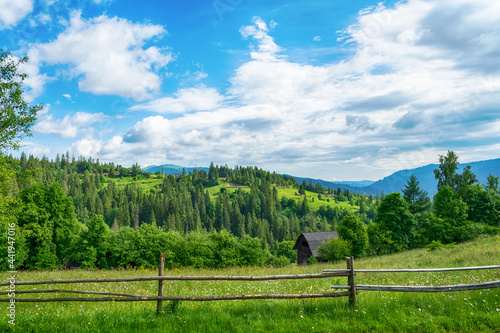 Beautiful mountains. Wooden fence from a log house. Small wooden house. Carpathians. Ukraine.