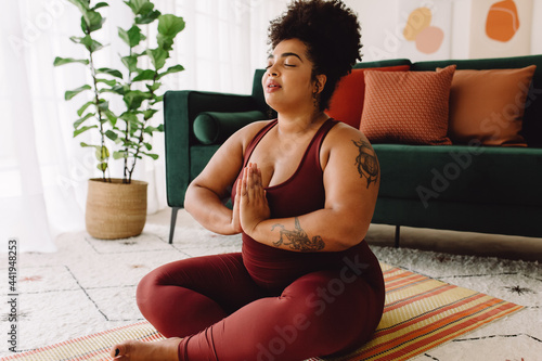 Healthy woman practicing relaxation yoga at home photo