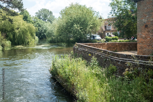 Romsey, Hampshire, UK – June 15 2021. The historic Sadler’s Mill on the River Test on the Romsey Heritage trail. Captured on a bright and sunny day
