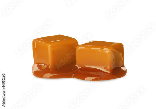 Caramel candies with topping on white background