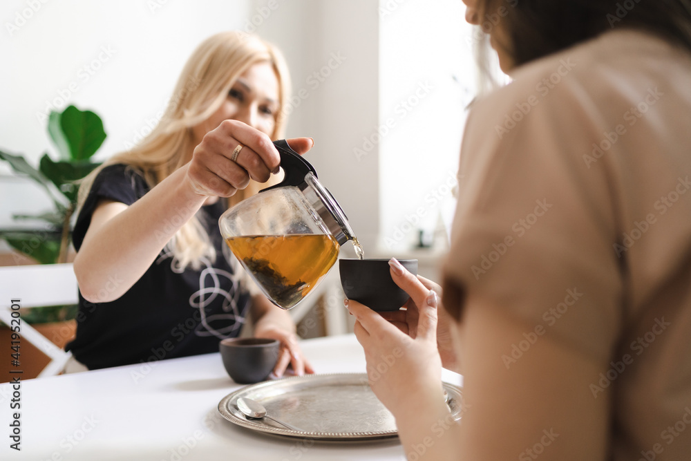 Mom, I can share everything with you. Mother and her daughter are sitting in the kitchen having a cup of tea and talking. Mom, I can share everything with you. Mother and her daughter are sitting in the kitchen having a cup of tea and talking.
