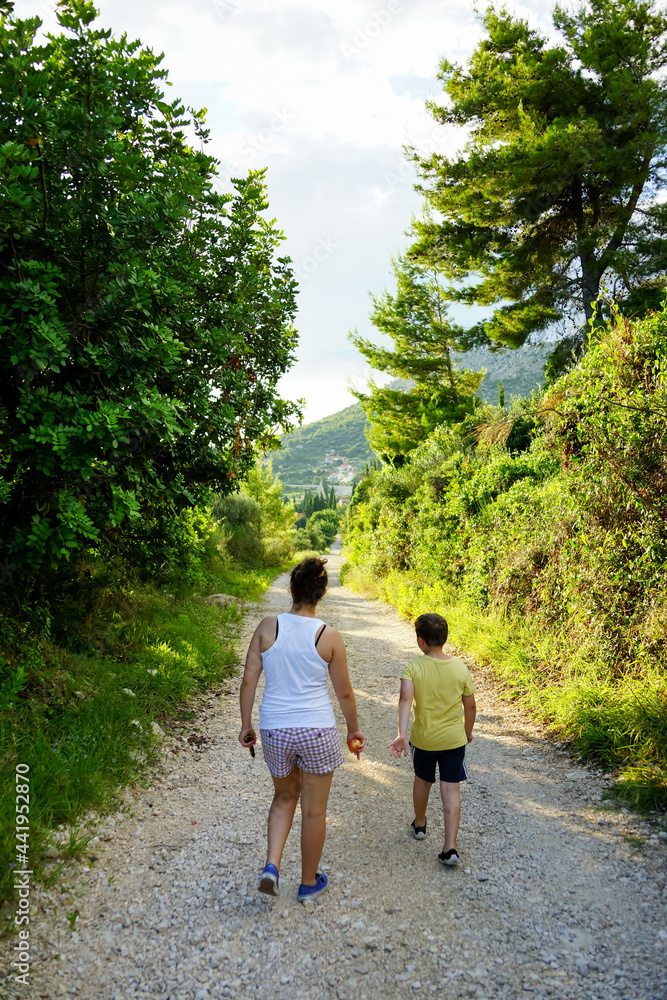 kids walking on gravel road in Croatia mountains kids walking on gravel road in Croatia mountains
