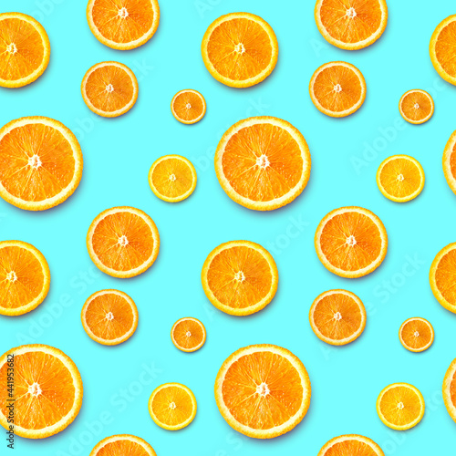 Ripe orange slices on a bright background. Seamless background.