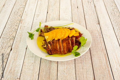 Orange duck dish with orange slices on top cooked with Chinese restaurant recipe