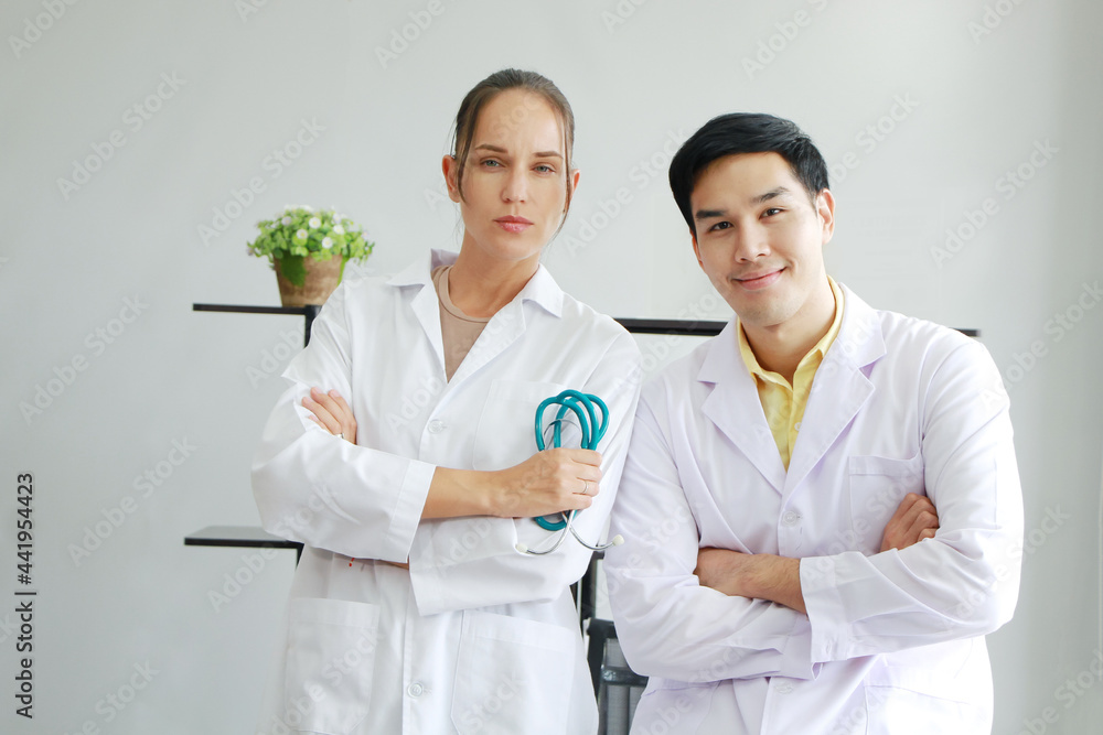 Smiling teamwork and smart of Young Caucasian Female and Asian male psychiatrist are specialist in psychiatry in Clinical treatment for emotional symptoms. Smiling teamwork and smart of Young Caucasian Female and Asian male psychiatrist are specialist in psychiatry in Clinical treatment for emotional symptoms.
