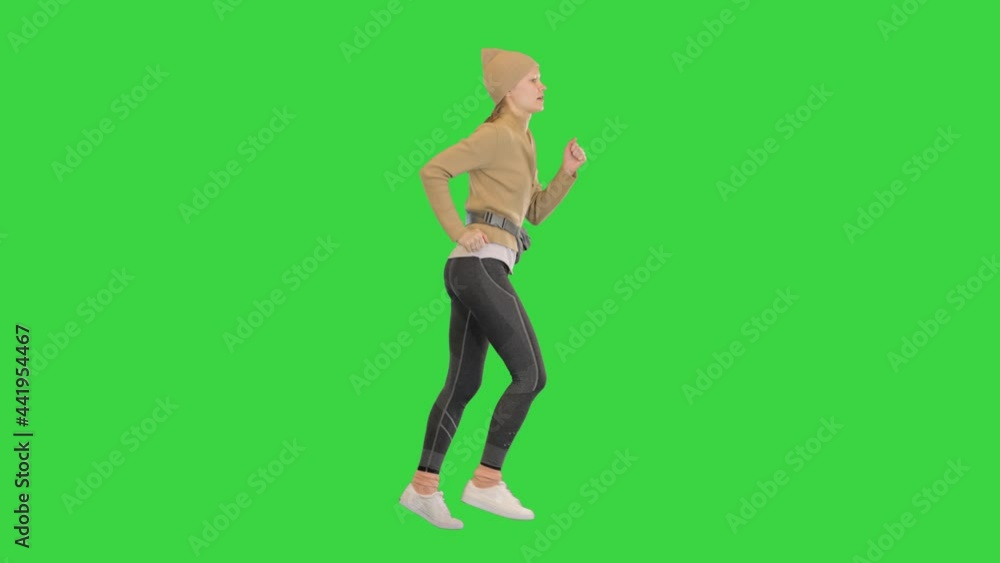 Female runner training jogging outdoors on a Green Screen, Chroma Key. Female runner training jogging outdoors on a Green Screen, Chroma Key.