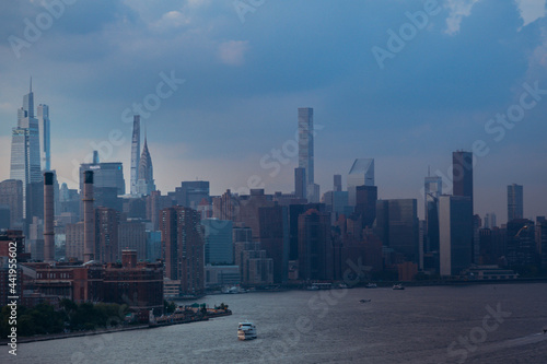 Nyc skyline in cloudy weather during setting sun