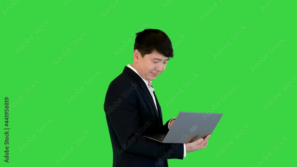 Asian man working with laptop on a Green Screen, Chroma Key. Asian man working with laptop on a Green Screen, Chroma Key.