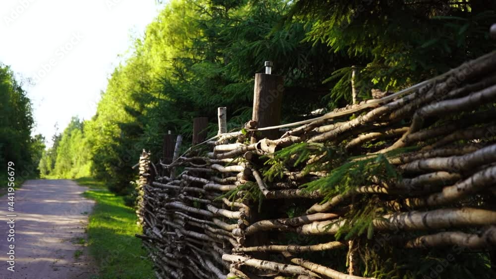 Wooden fence along the forest road Wooden fence along the forest road