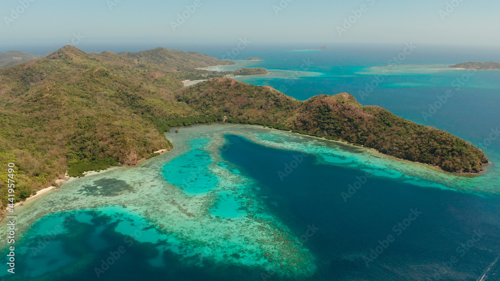 aerial view tropical island Bulalacao with blue lagoon, coral reef and sandy beach. Palawan, Philippines. Islands of the Malayan archipelago with turquoise lagoons. aerial view tropical island Bulalacao with blue lagoon, coral reef and sandy beach. Palawan, Philippines. Islands of the Malayan archipelago with turquoise lagoons.