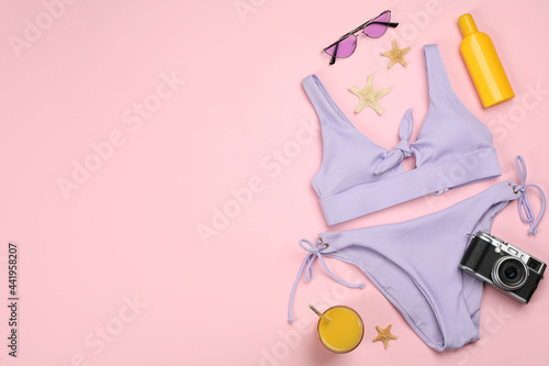 Flat lay composition with beach objects on pink background, space for text