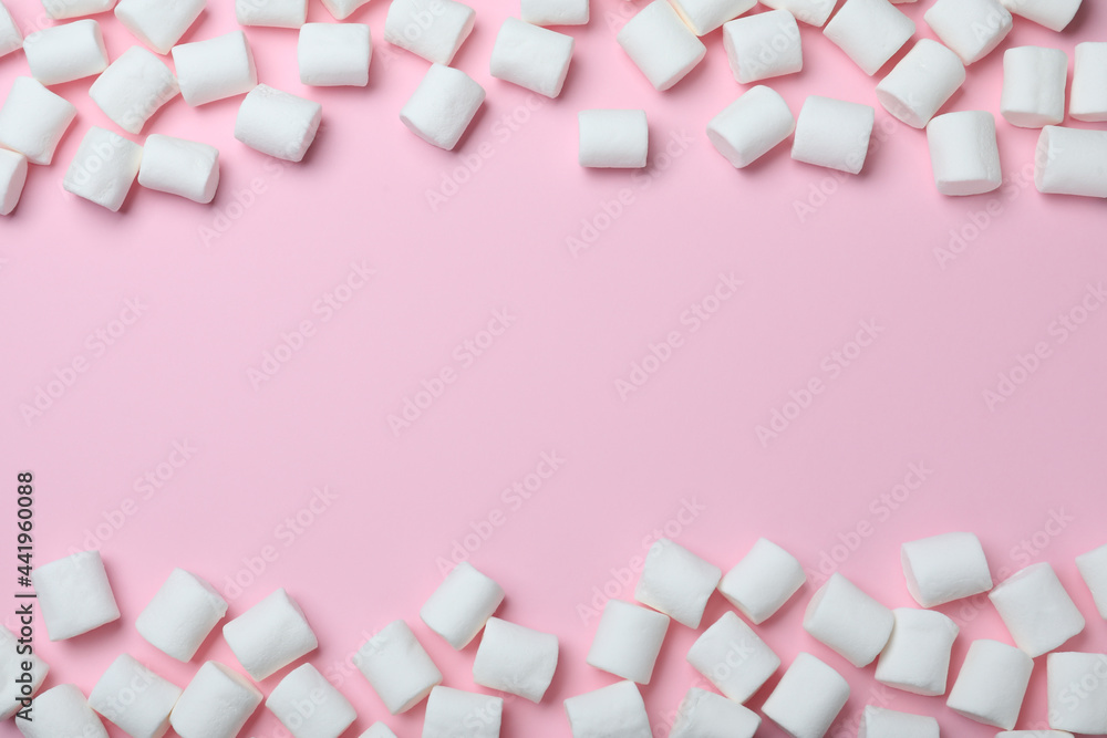 Delicious puffy marshmallows on pink background, flat lay. Space for text Delicious puffy marshmallows on pink background, flat lay. Space for text