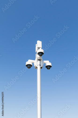 White pole with white 360 degree video surveillance cameras