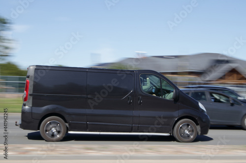 A black van is driving down the street at high speed. Motion blur © Armands photography