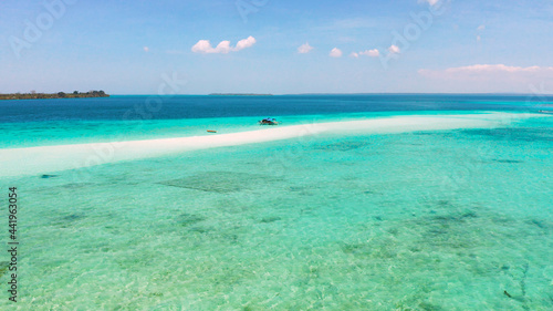 White sandy beach in the lagoon with turquoise water on a tropical island. Mansalangan sandbar. Beach at the atoll. Summer and travel vacation concept. Balabac, Palawan, Philippines.