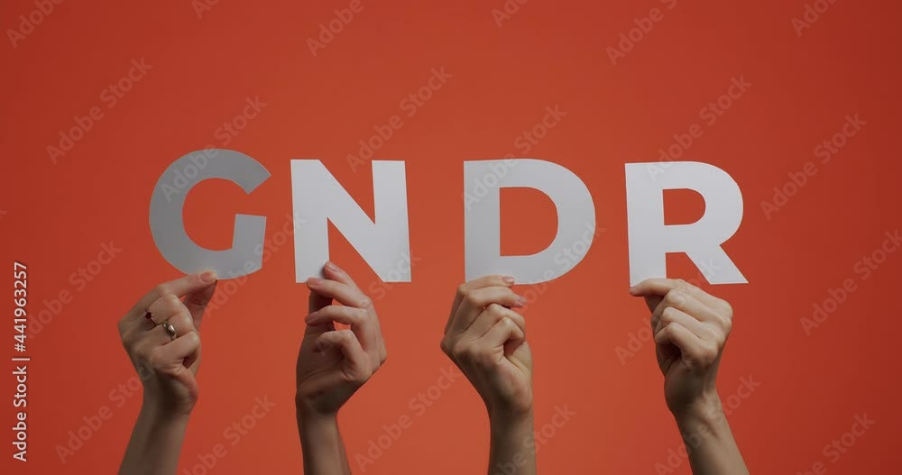 Hands raising up showing abbreviated word gender. 4k video of arms with letters made of carves paper Hands raising up showing abbreviated word gender. 4k video of arms with letters made of carves paper