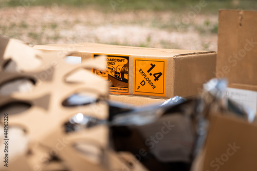 Explosive triangle placard sign on the carton box, to demonstrate the dangerous material inside. Industrial safety sign and symbol on the object. photo