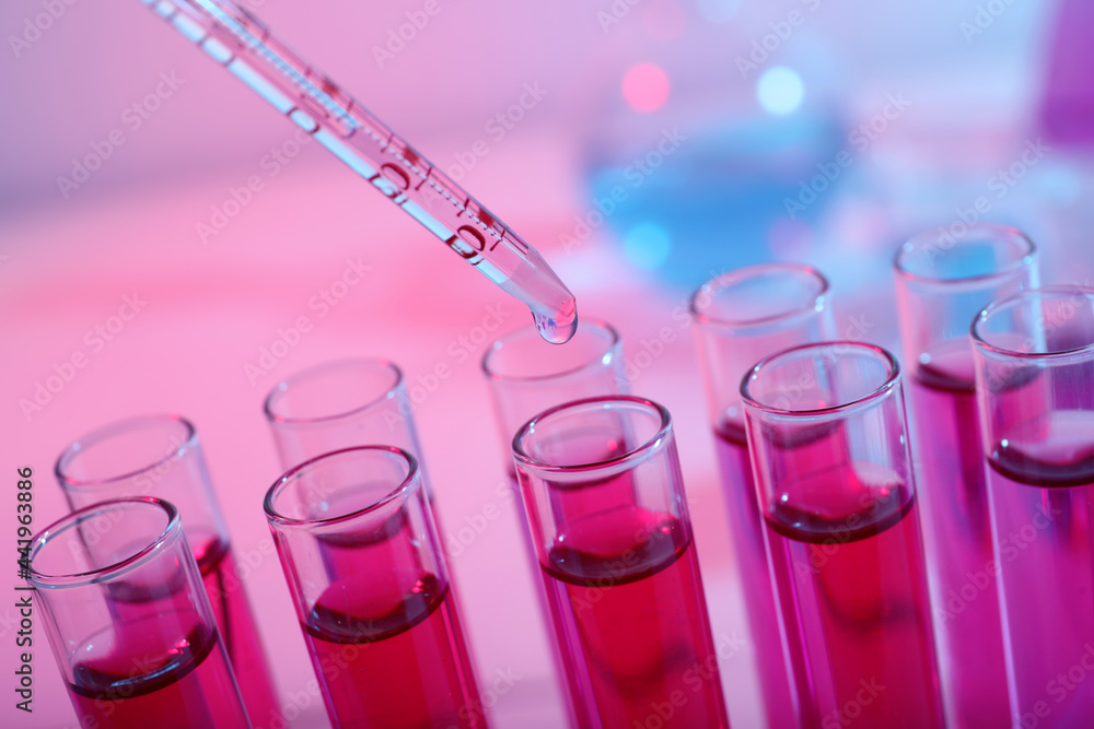 Dripping reagent into test tube with red liquid, closeup. Laboratory analysis Dripping reagent into test tube with red liquid, closeup. Laboratory analysis