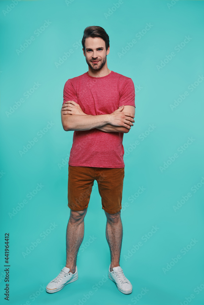 Full length of handsome young man in casual clothing looking at camera Full length of handsome young man in casual clothing looking at camera