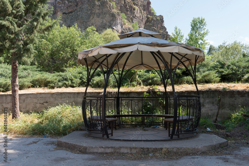 natural wooden bench and iron pergola